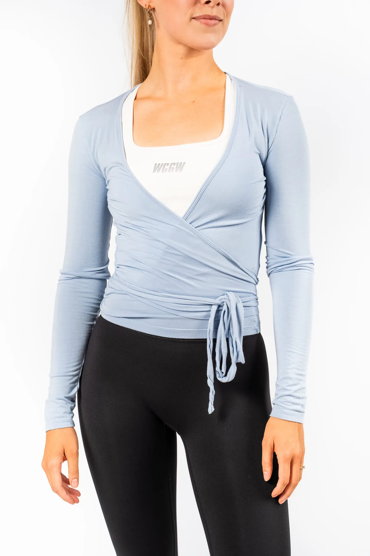 Woman in a light blue WCGW pilates wrap top
